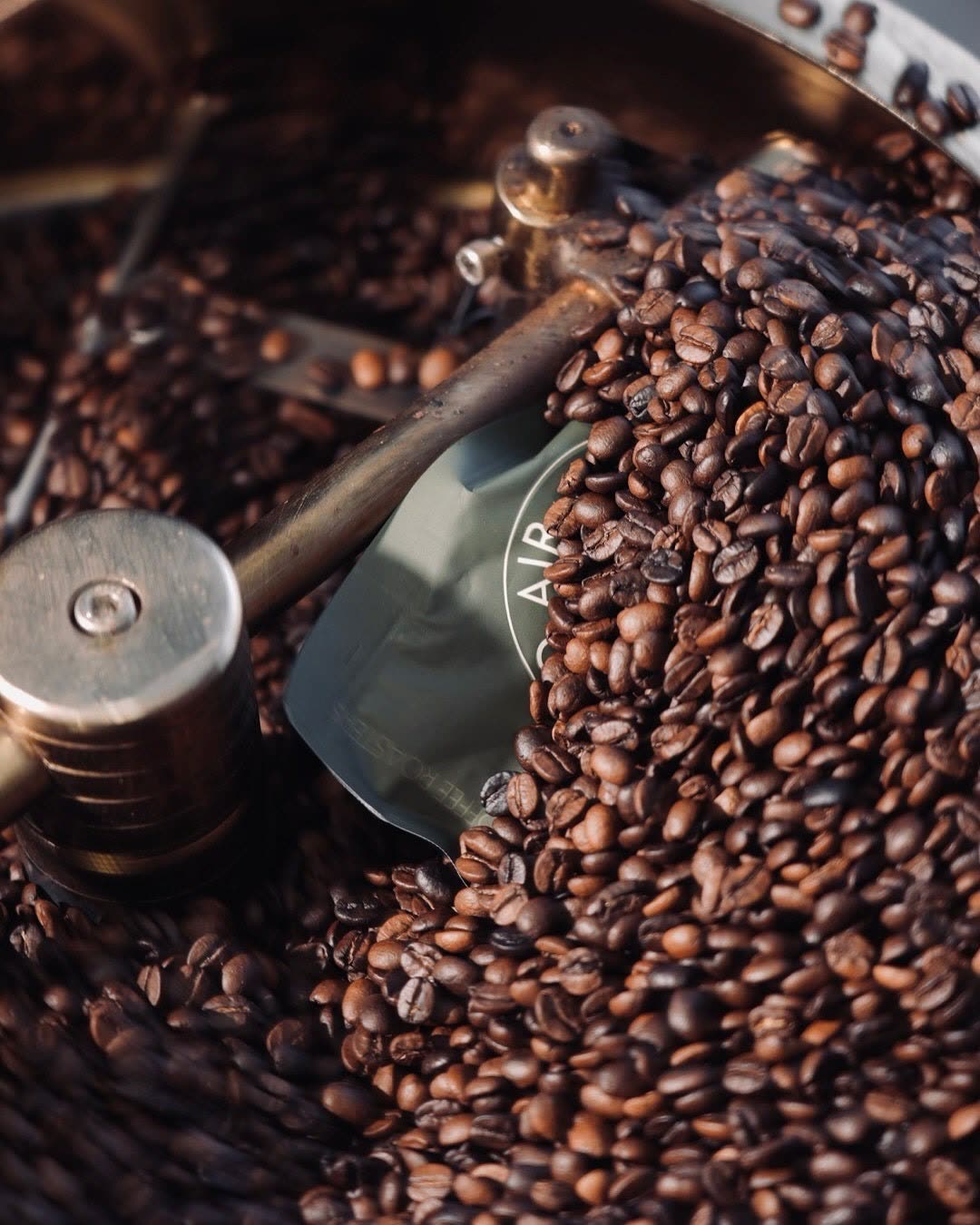 Fresh-roasted beans pouring from the roaster